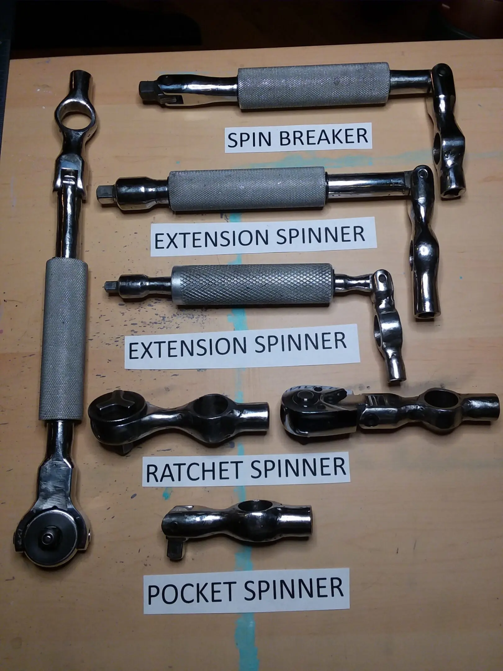 682d1ddf78fc9_Spin B-3 A bunch of different types of wrenches on top of a table.